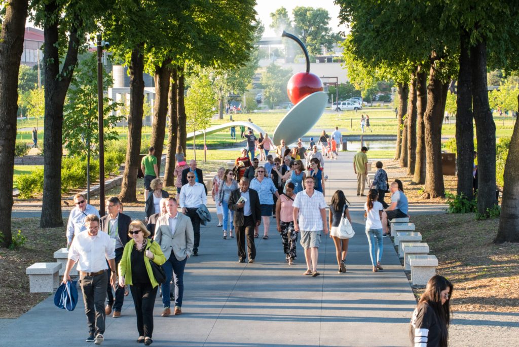 A crowded sidewalk in a public park