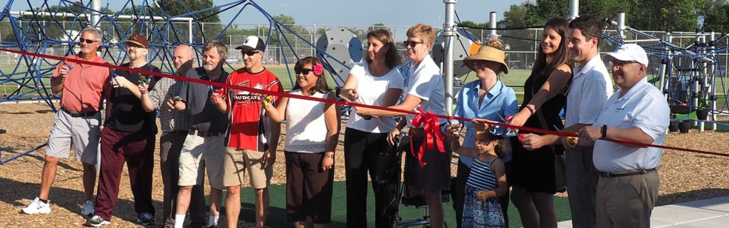 Toro Park award winners cutting a red ribbon
